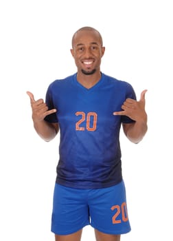 A young African American soccer player standing in the studio in his blue.uniform pointing to himself, isolated for white background.