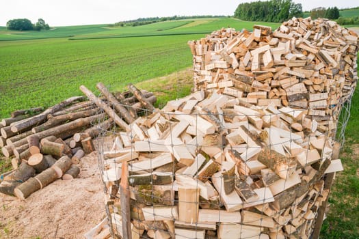 Logs in a metal grid cage on a lumber yard