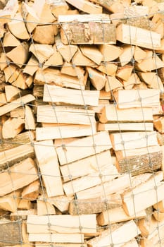 Logs in a metal grid cage on a lumber yard