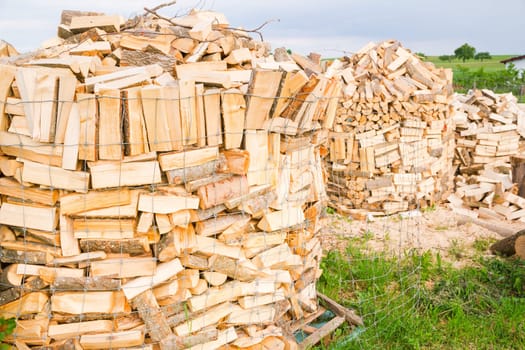 Logs in a metal grid cage on a lumber yard