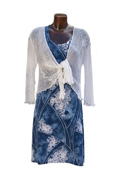 Dress isolated. Closeup of colorful blue white elegant stylish sleeveless summer dress with a white bolero above it on mannequin isolated on a white background. Summer fashion.