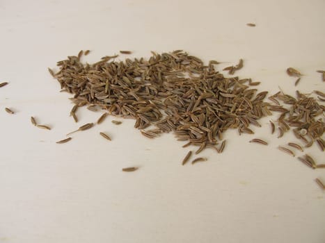Caraway seeds, Carum carvi, on a wooden board