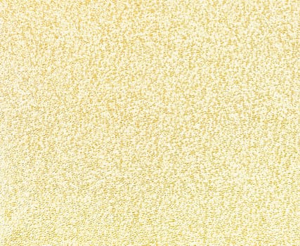 Yellow golden glitter foil textured background closeup