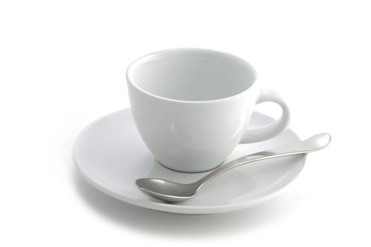 An empty white coffee cup and saucer and spoon isolated on a white background