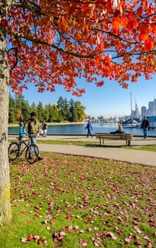 Vancouver, Canada - October 20,2018: Unidentified tourists at Stanley Park with autumn color of Maple trees in Vancouver, British Columbia, Canada.