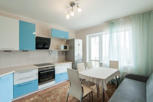 Russia, Moscow- June 05, 2019: interior room apartment. standard repair decoration in hostel. kitchen and dining room