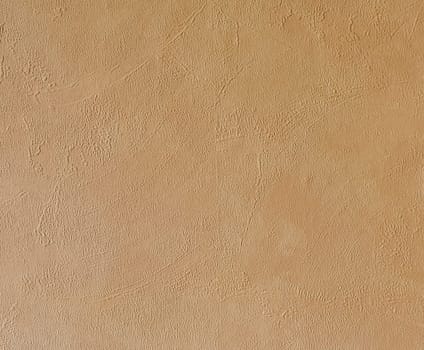 Bright beige rough plastered house wall frame as a background