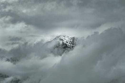 Snowy Peak of Mountain Range in Clouds