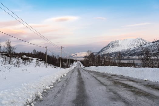 icy road on the bank of Ullsfjord in County Troms Norway