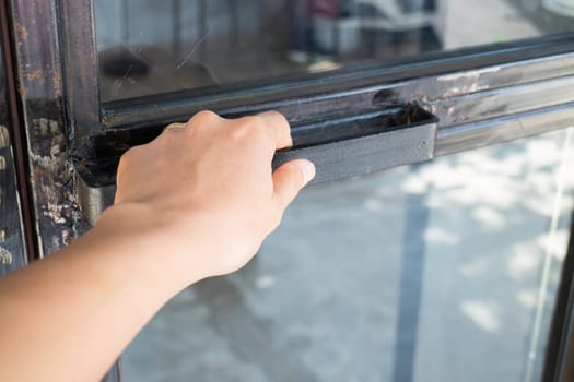 Hand on black door holder, stock photo