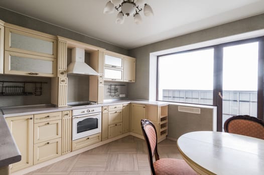 Russia, Moscow- June 11, 2019: interior room apartment. standard repair decoration in hostel. modern kitchen, dining area