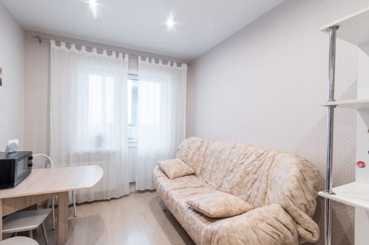 Russia, Moscow- June 11, 2019: interior room apartment. standard repair decoration in hostel. modern kitchen, dining area
