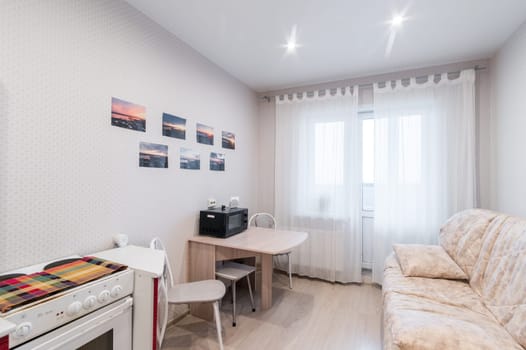 Russia, Moscow- June 11, 2019: interior room apartment. standard repair decoration in hostel. modern kitchen, dining area