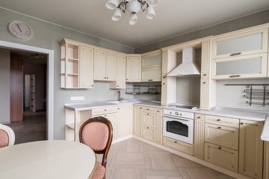 Russia, Moscow- June 11, 2019: interior room apartment. standard repair decoration in hostel. modern kitchen, dining area