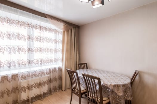 Russia, Moscow- June 11, 2019: interior room apartment. standard repair decoration in hostel. modern kitchen, dining area