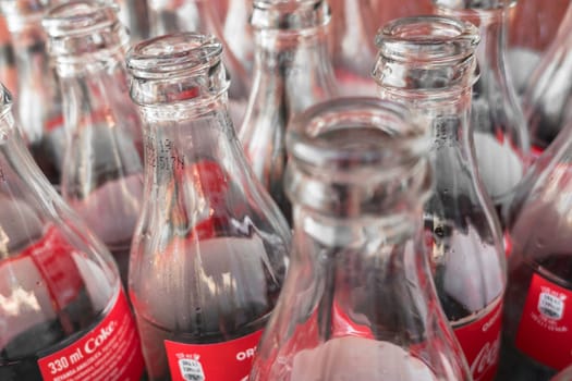 Empty glass bottles of Coca Cola, close-up. View from above. Italy February 19 2019.