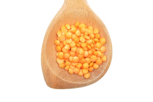 Red lentils on wooden spoon and white background