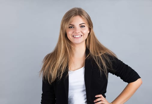 Portrait of a young charming girl, isolated on grey