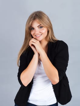 Portrait of a charming young woman, isolated on grey