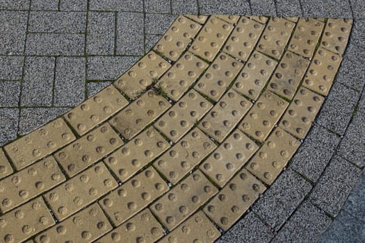 Block tactile paving for blind handicap. Tactile paving for blind handicap on tiles pathway before street crossing