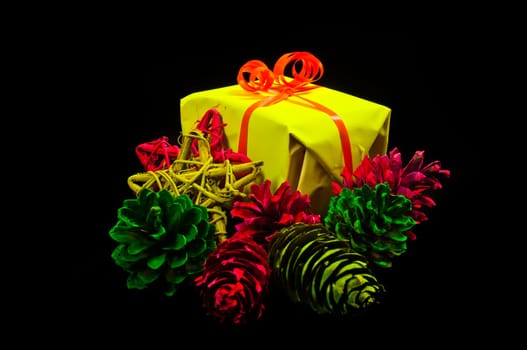Gifts, christmas balls and stars in neon colors on black background