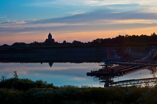 Panorama Stenden with church, miller and gravel pit in the sunset Kerken-Stenden, Germany