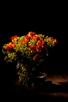 orange bouquet of roses in glass vase