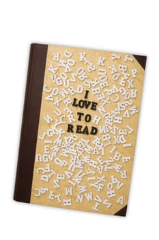 Concept I Love to read with Toy Letters and a old Book on white background