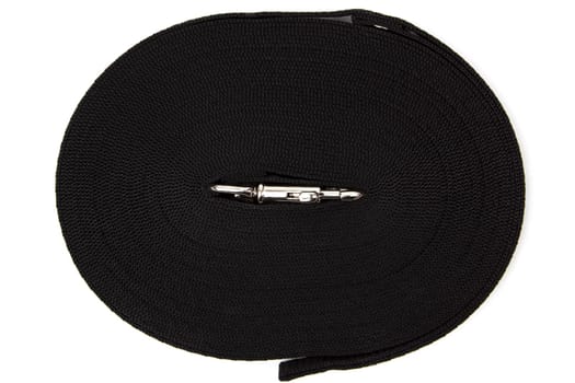 Black rolled up dog leash on white background