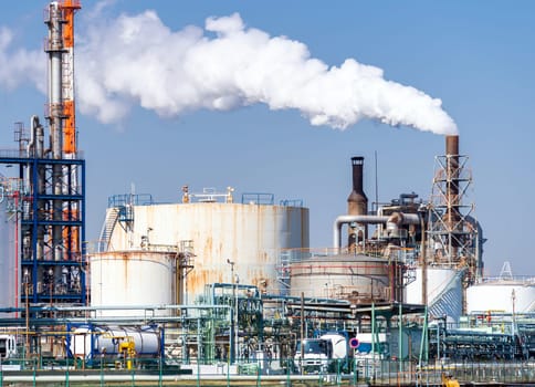 Chemical Factory plant with gas storage and structure of pipeline with smoke from smokestack in Kawasaki City near Tokyo Japan