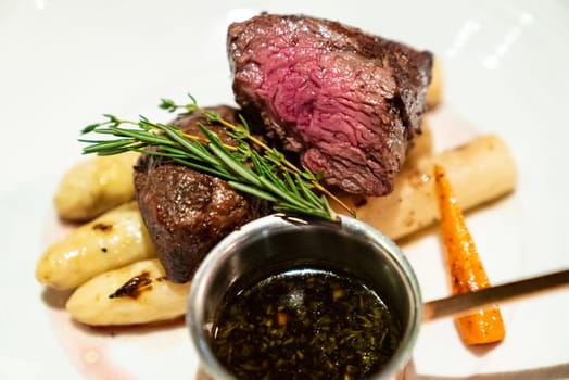 Grilled Beef Tenderloin wagyu with white asparagus decorate with edible flowers