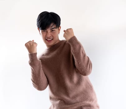 Portrait of good-looking smart Teenager young asian adult boy wearing brown sweater for winter on white background
