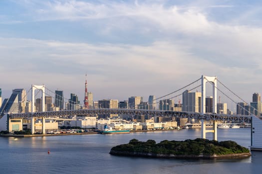 Aerial view of Tokyo skylines with Rainbow bridge and tokyo tower over Tokyo bay in daytime from Odaiba in Tokyo city Kanto Japan.