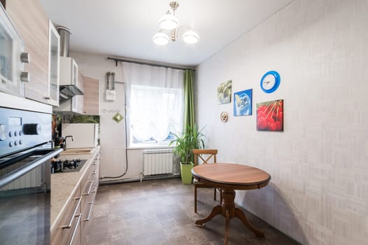 Russia, Moscow- June 11, 2019: interior room apartment. standard repair decoration in hostel. kitchen and dining room