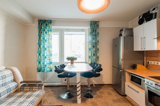 Russia, Moscow- June 11, 2019: interior room apartment. standard repair decoration in hostel. kitchen and dining room