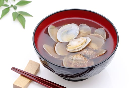 Japanese soy sauce soup with asari clams in a bowl on white background