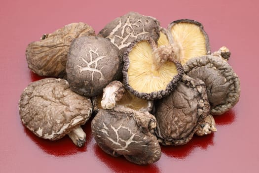 Japanese dried shiitake mushrooms on red background