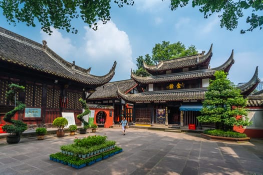 Chengdu, China -  July 2019 : Pilgrim or tourist walking in the courtyard of the Buddhist Wenshu Monastery, Chengdu, Sichuan Province