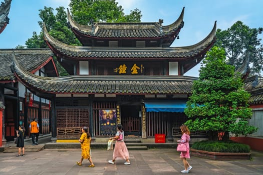 Chengdu, China -  July 2019 :  Female tourists walking in the courtyard of the Buddhist Wenshu Monastery, Sichuan Province