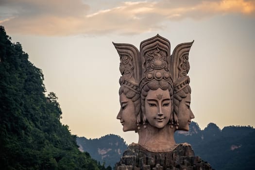 Wulingyuan, China -  August 2019 : Four faced sculpture at the entrance to the Romance Park located in Suoxiyu Town in Wulingyuan.  It is famous for the show of Zhangjiajie Romance performance.