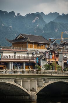 Wulingyuan, China - August 2019 : Wide arched bridge over Suoxiyu river in the ancient part of Wullingyuan town, Hunan Province