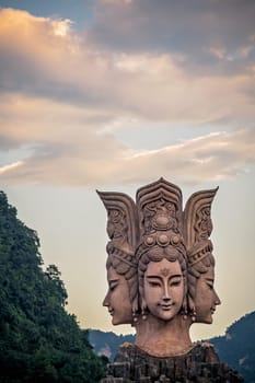Wulingyuan, China -  August 2019 : Four faced sculpture at the entrance to the Romance Park located in Suoxiyu Town in Wulingyuan.  It is famous for the show of Zhangjiajie Romance performance.