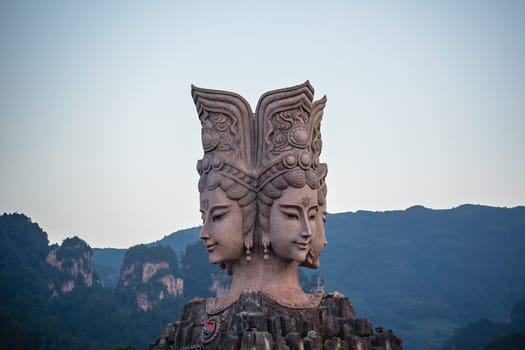 Wulingyuan, China -  August 2019 : Four faced sculpture at the entrance to the Romance Park located in Suoxiyu Town in Wulingyuan.  It is famous for the show of Zhangjiajie Romance performance.