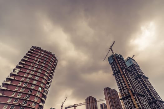 Chengdu, China -  July 2019 : Cranes on the building site of brand new high rise living apartments in the centre of town, Sichuan Province