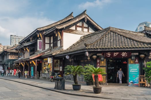 Chengdu, China -  July 2019 : Street scene in the city of Chengdu in summer, old traditional chinese buildings in the background, Sichuan Province