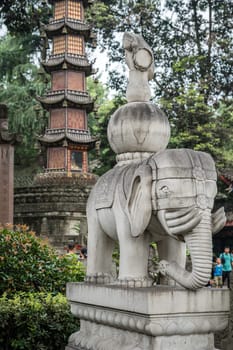 Chengdu, China -  July 2019 :  Large elephant sculpture figure in front of the landmark Thousand Buddha Pagoda in the courtyard of the Wenshu Monastery