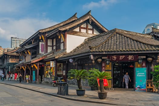 Chengdu, China -  July 2019 :  Street scene in the city of Chengdu in summer, old traditional chinese buildings in the background, Sichuan Province