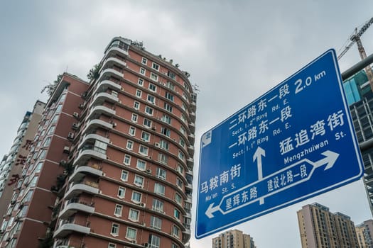 Chengdu, China -  July 2019 : Living apartments flats and road sign showing directions in the town centre, Sichuan Province