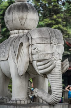 Chengdu, China -  July 2019 :  Large elephant sculpture figure in front of the landmark Thousand Buddha Pagoda in the courtyard of the Wenshu Monastery