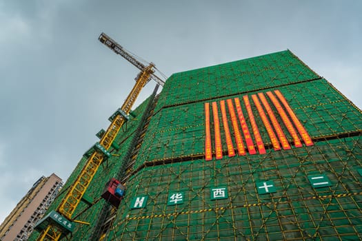 Chengdu, China -  July 2019 : Cranes on the building site of brand new high rise living apartments in the centre of town, Sichuan Province